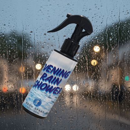 Spray bottle labeled 'Evening Rain Shower' against a rainy window background