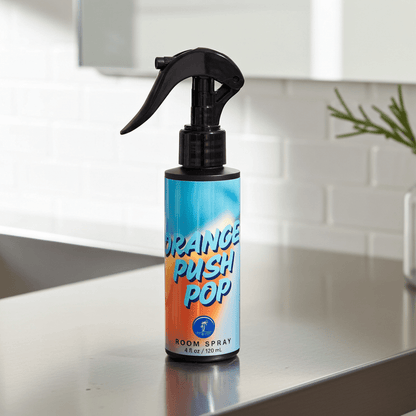 Spray bottle labeled 'Orange Push Pop' on a kitchen counter.