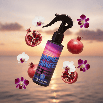 Room spray bottle with pomegranates and flowers against a sunset beach background