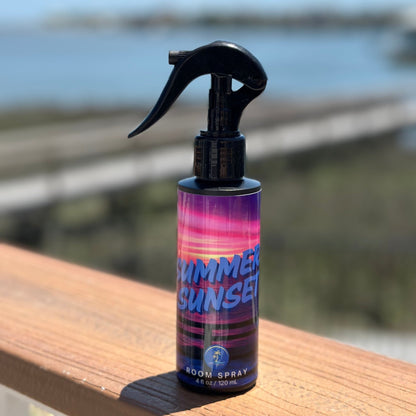 Summer Sunset summer room spray by Summerize sitting in front of a blurred tropical beach background